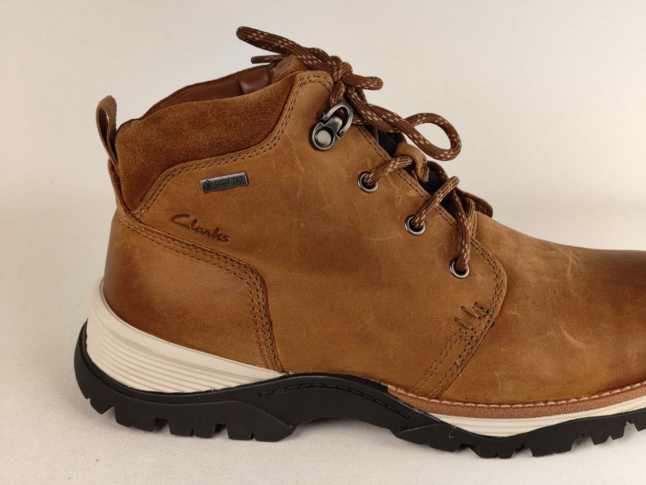 Brown leather boot with laces on a white background