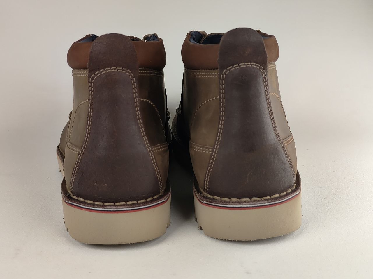 Pair of brown leather boots on a white background