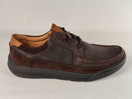 Brown leather shoe on a light gray background