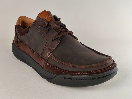 Brown leather shoe on a light gray background