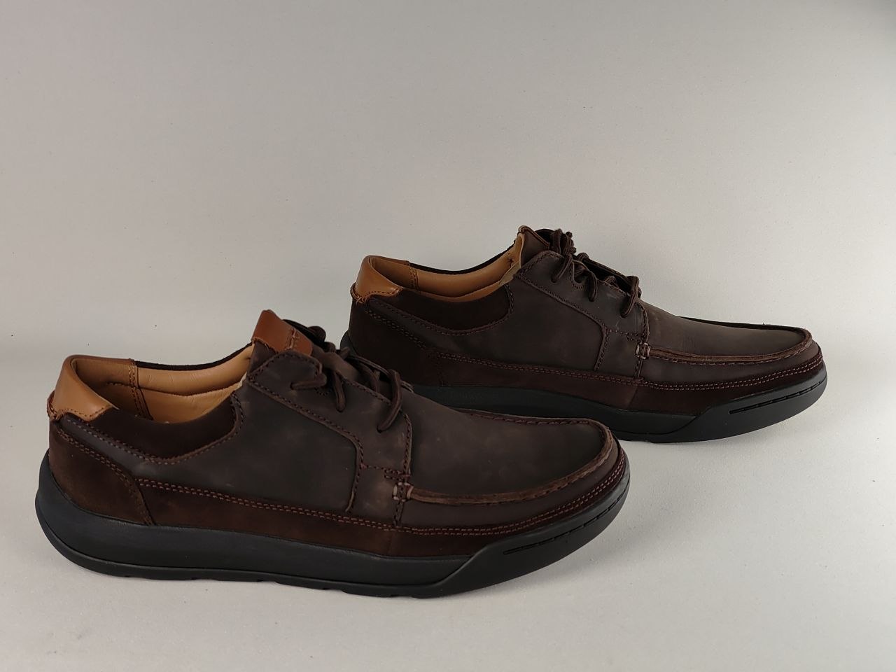 Pair of brown leather shoes on a light gray background