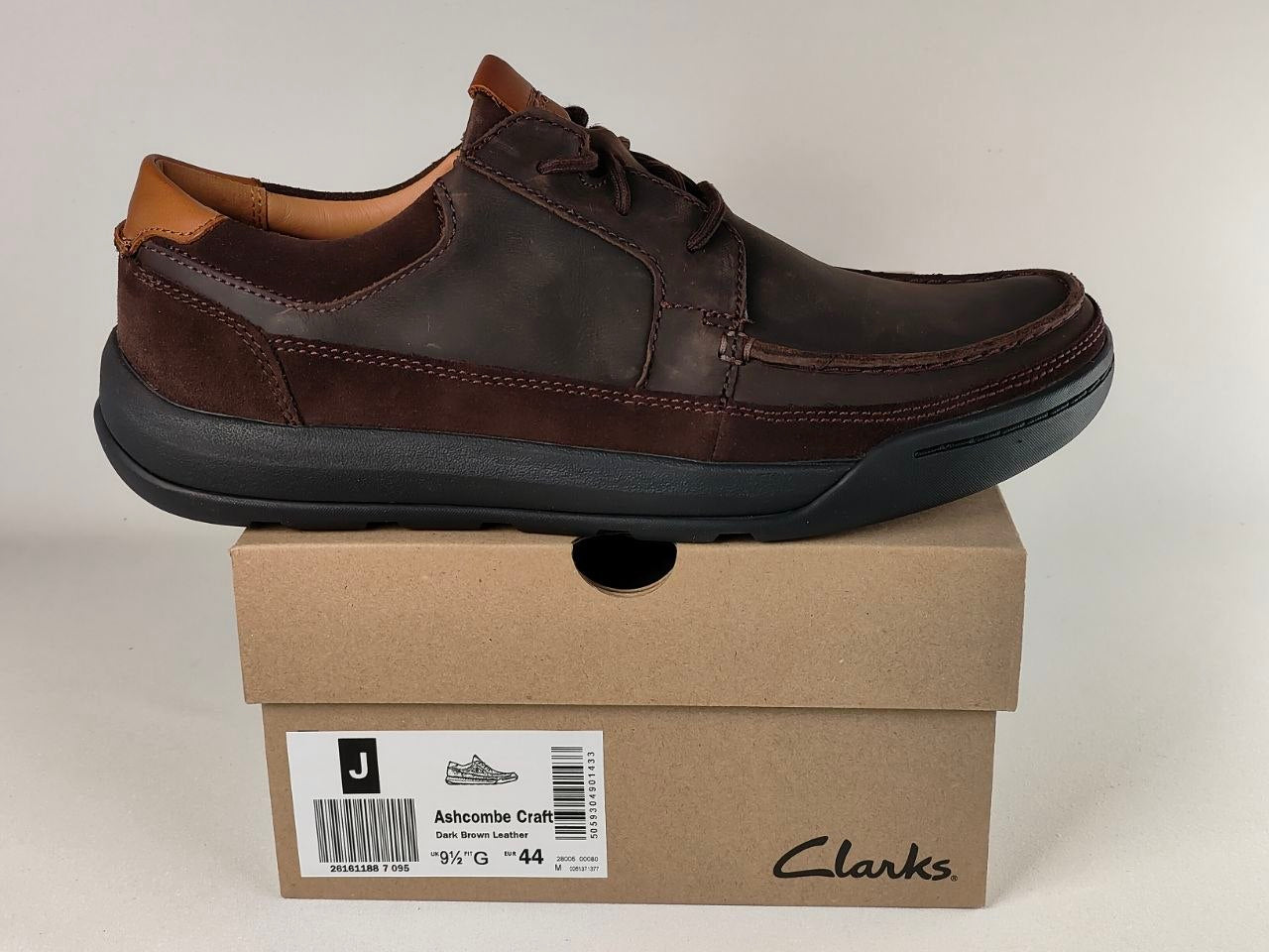 Brown leather shoe on a Clarks box with a plain background