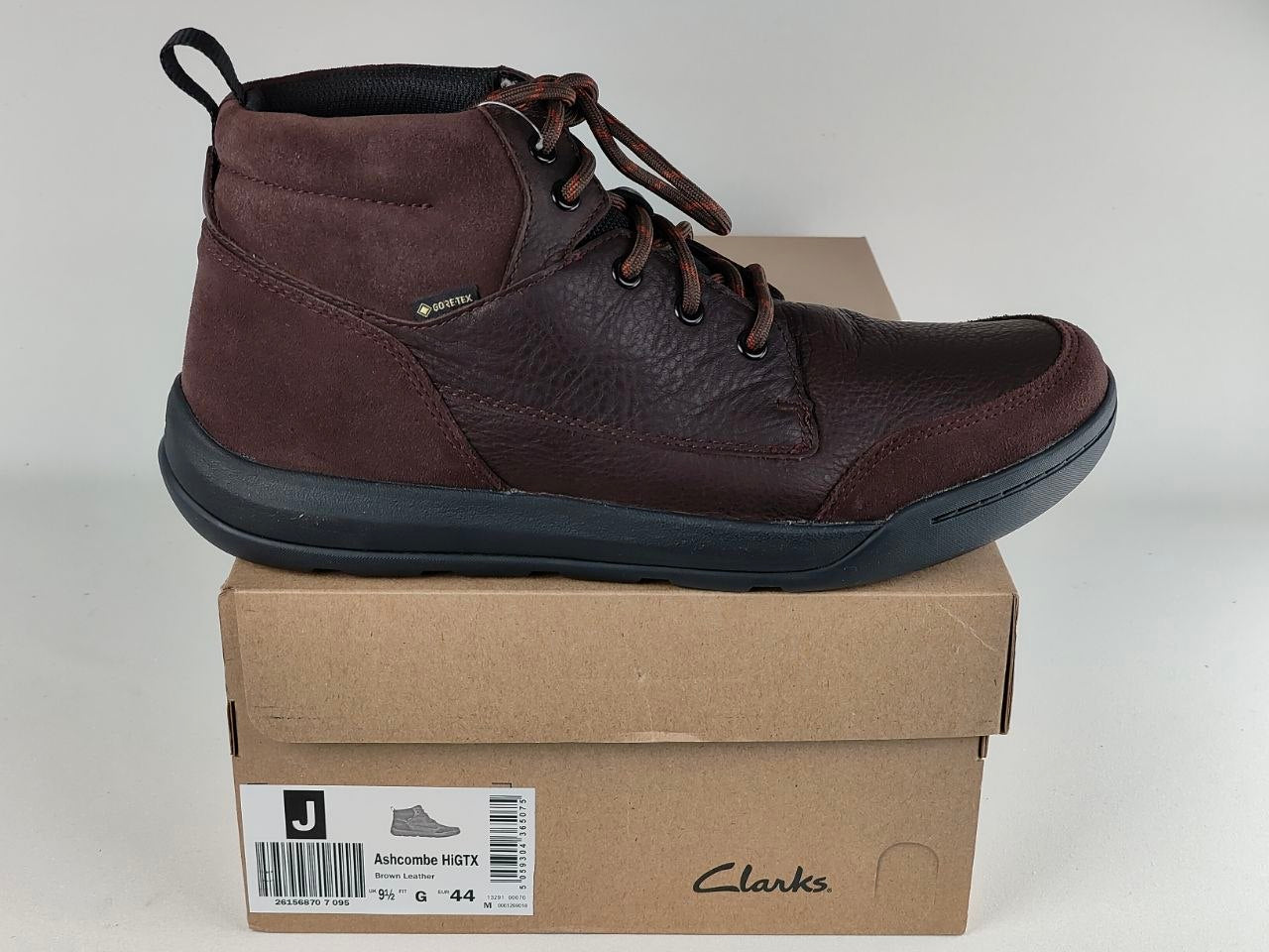 Brown leather boot on a Clarks shoe box with a white background