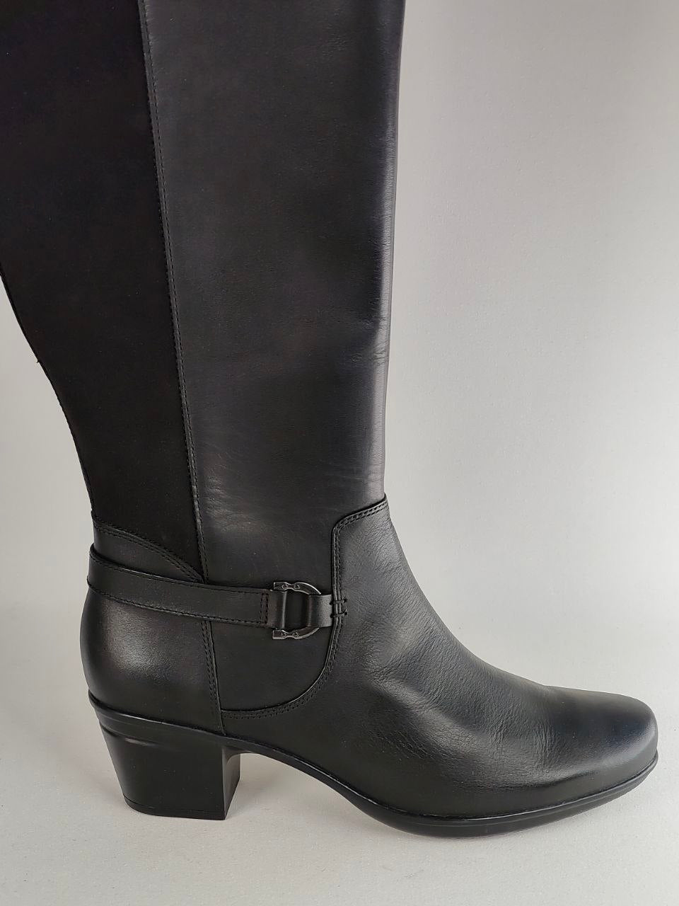 A black leather knee-high boot with a side buckle strap, shown from a side profile against a light gray background.