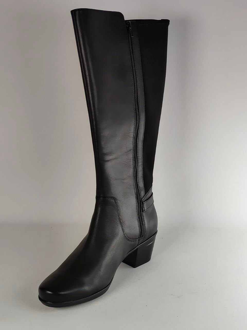 A single black leather knee-high boot with a side zipper, shown from a three-quarter angle against a neutral light gray background.