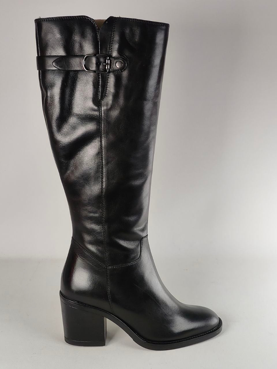 A single black leather knee-high boot with a block heel and a decorative strap detail near the top, shown against a neutral gray background.