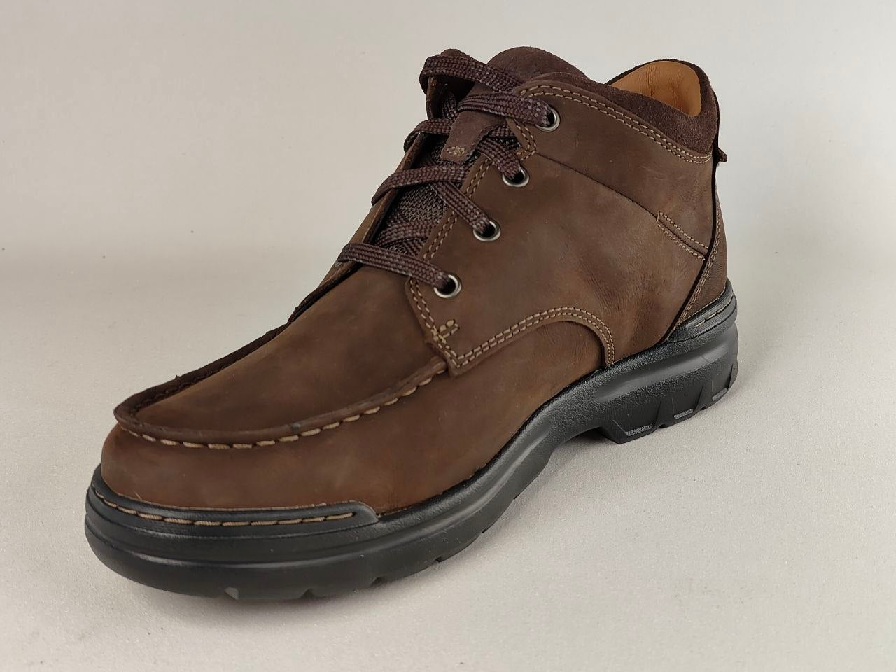 Brown leather shoe on a light gray background