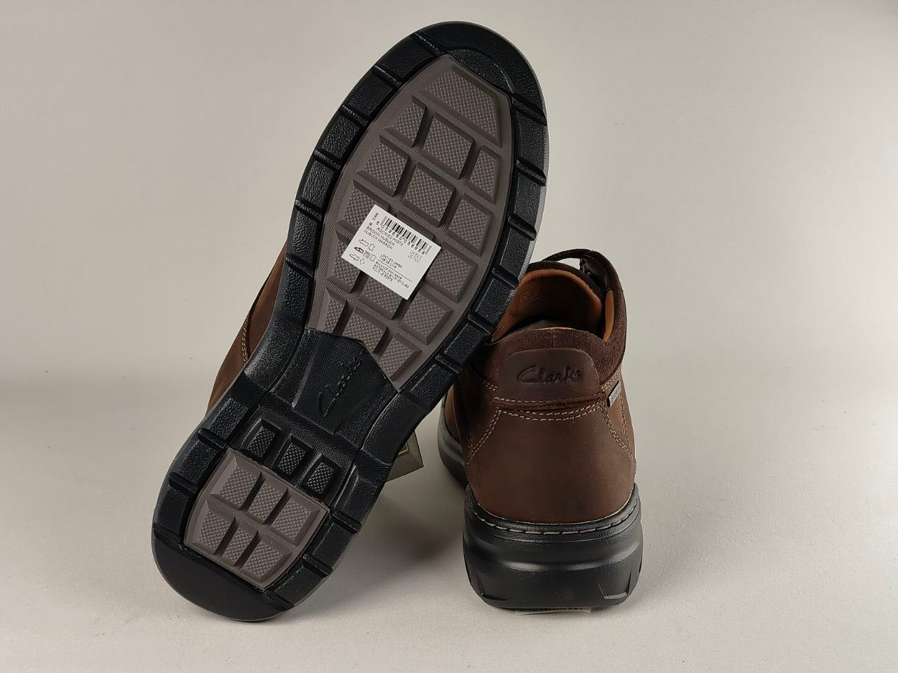 Brown shoes with black soles on a light gray background