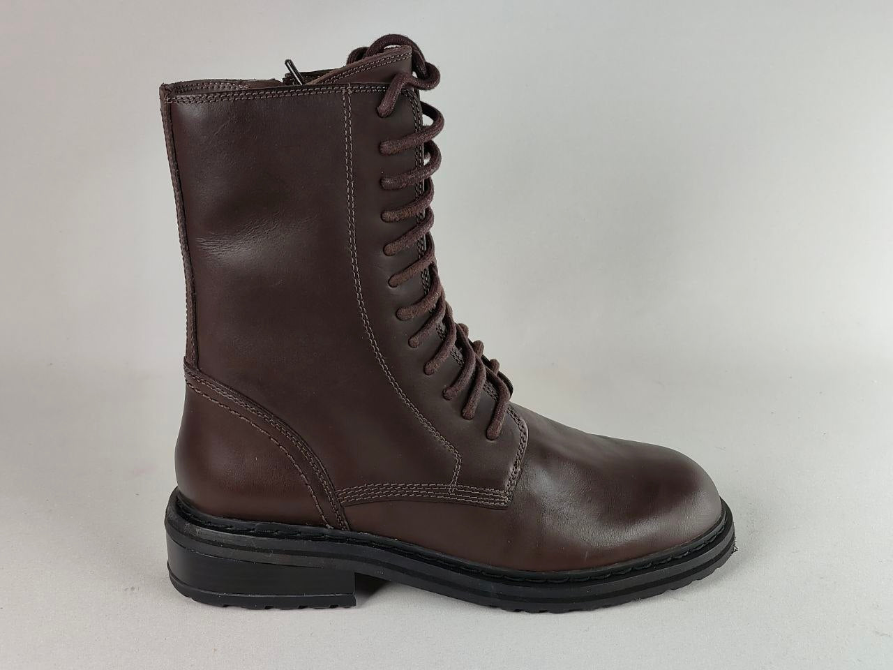 A dark brown leather lace-up boot with a black sole, shown in a side profile against a light gray background.