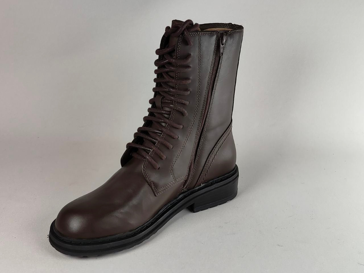 A dark brown leather lace-up boot with a side zipper and a black sole, photographed against a neutral light gray background.