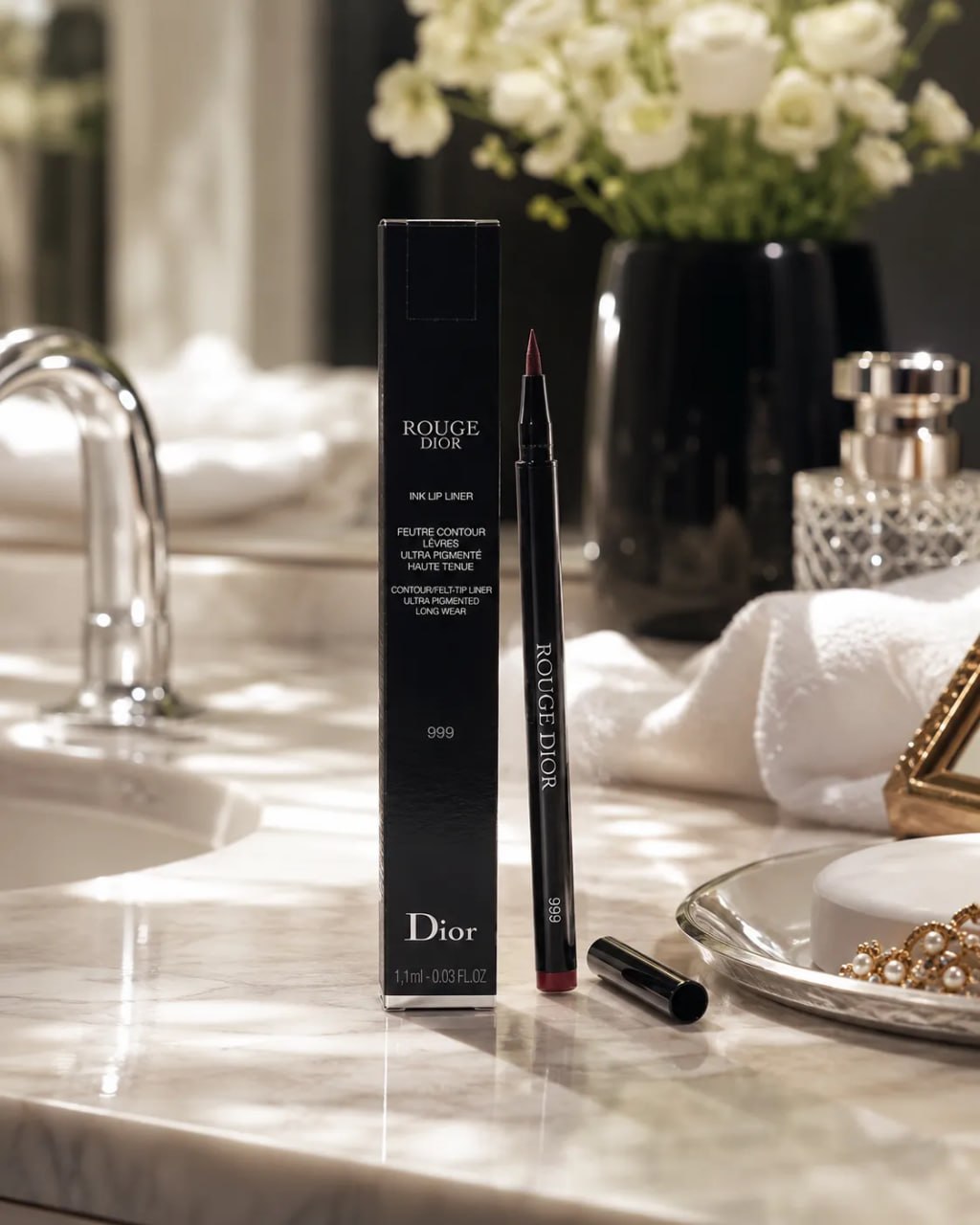 Dior makeup product on a marble counter with flowers in the background
