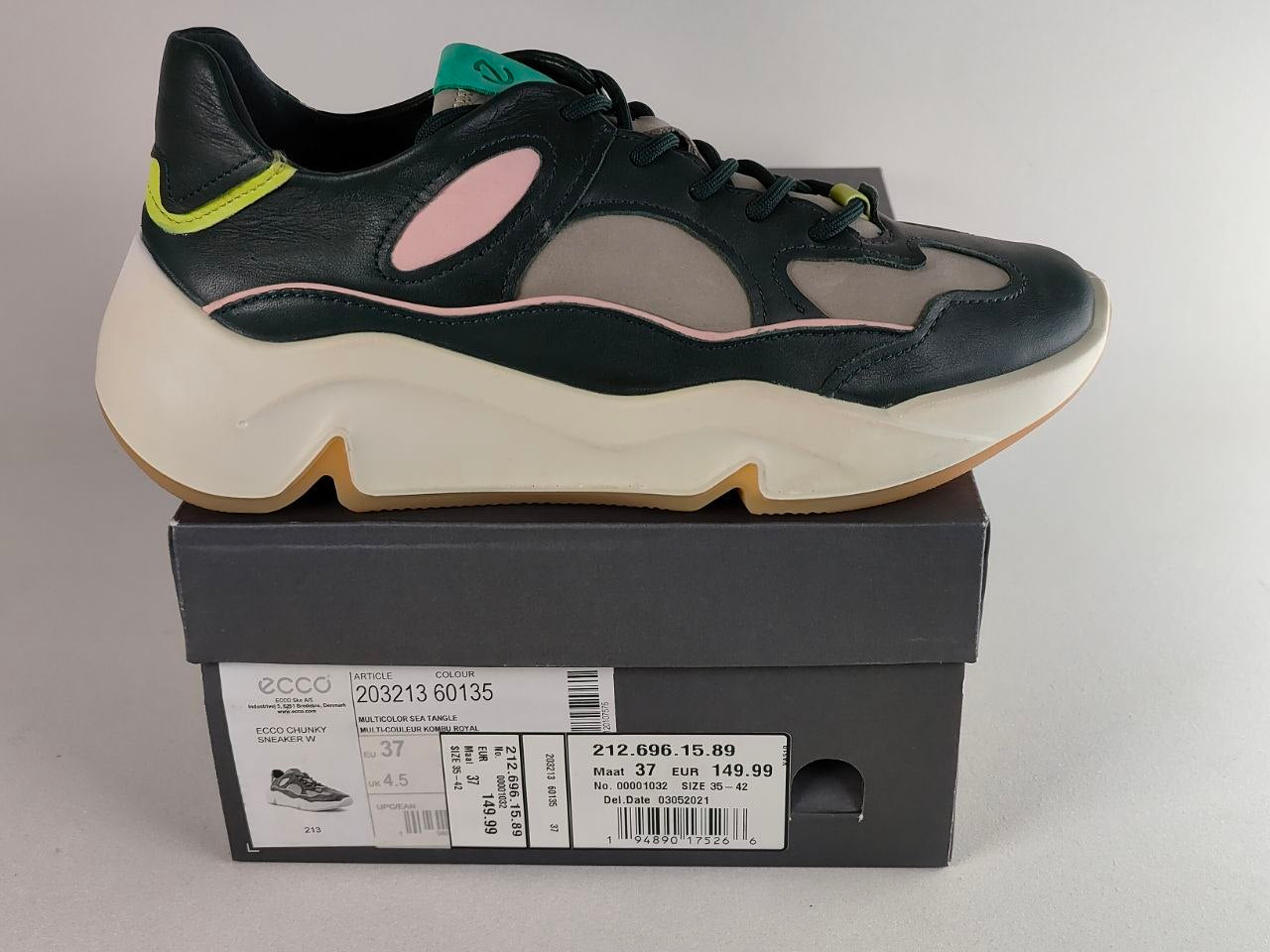 A black and gray ECCO chunky sneaker with a cream sole, displayed on top of its dark gray shoebox against a light gray background.