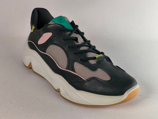 A low-top sneaker with a black leather upper, light gray mesh panels, a thick white midsole, and pastel pink accents, photographed on a neutral gray background.