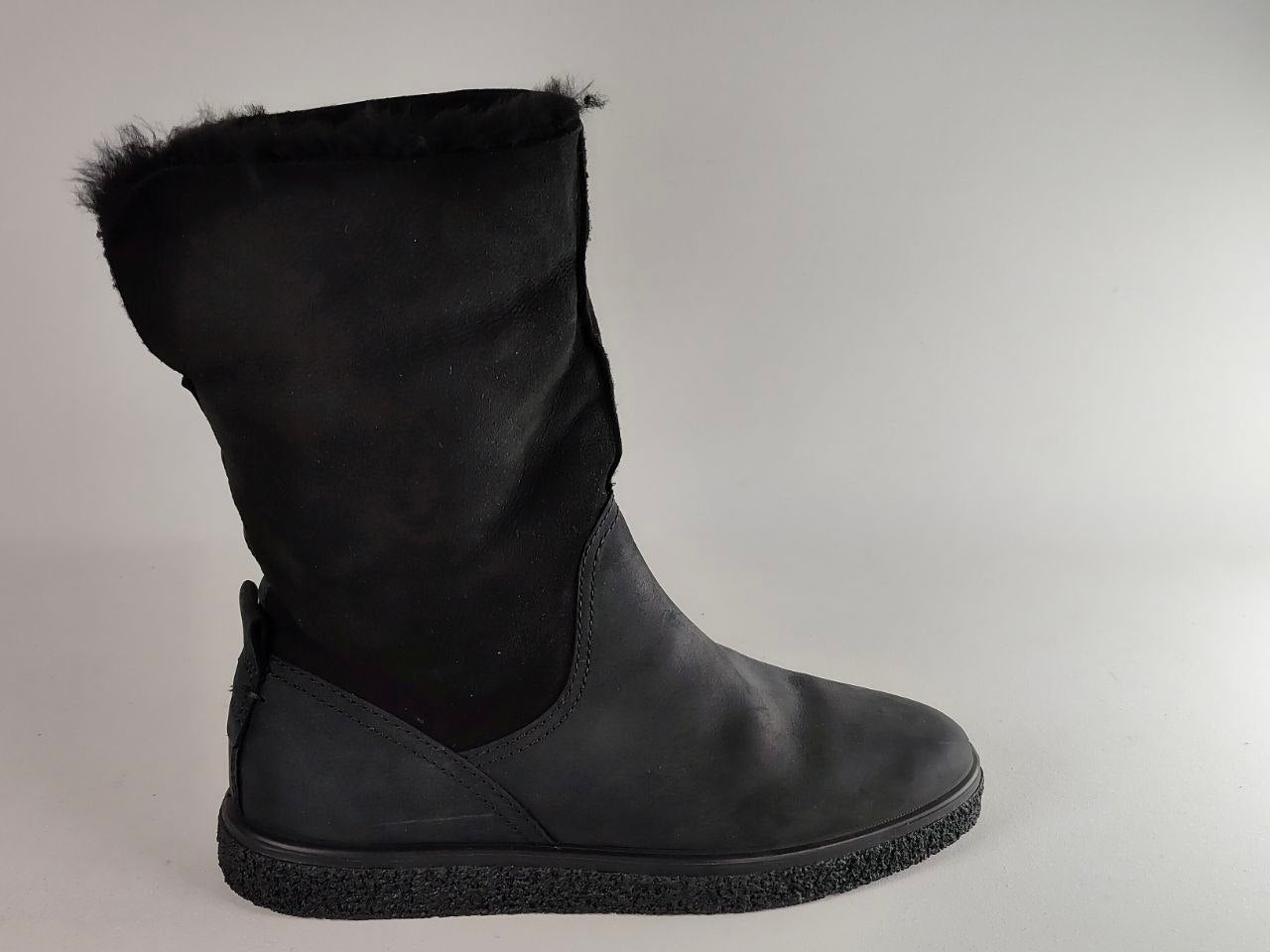 Black rubber boot with Muck logo on a white background