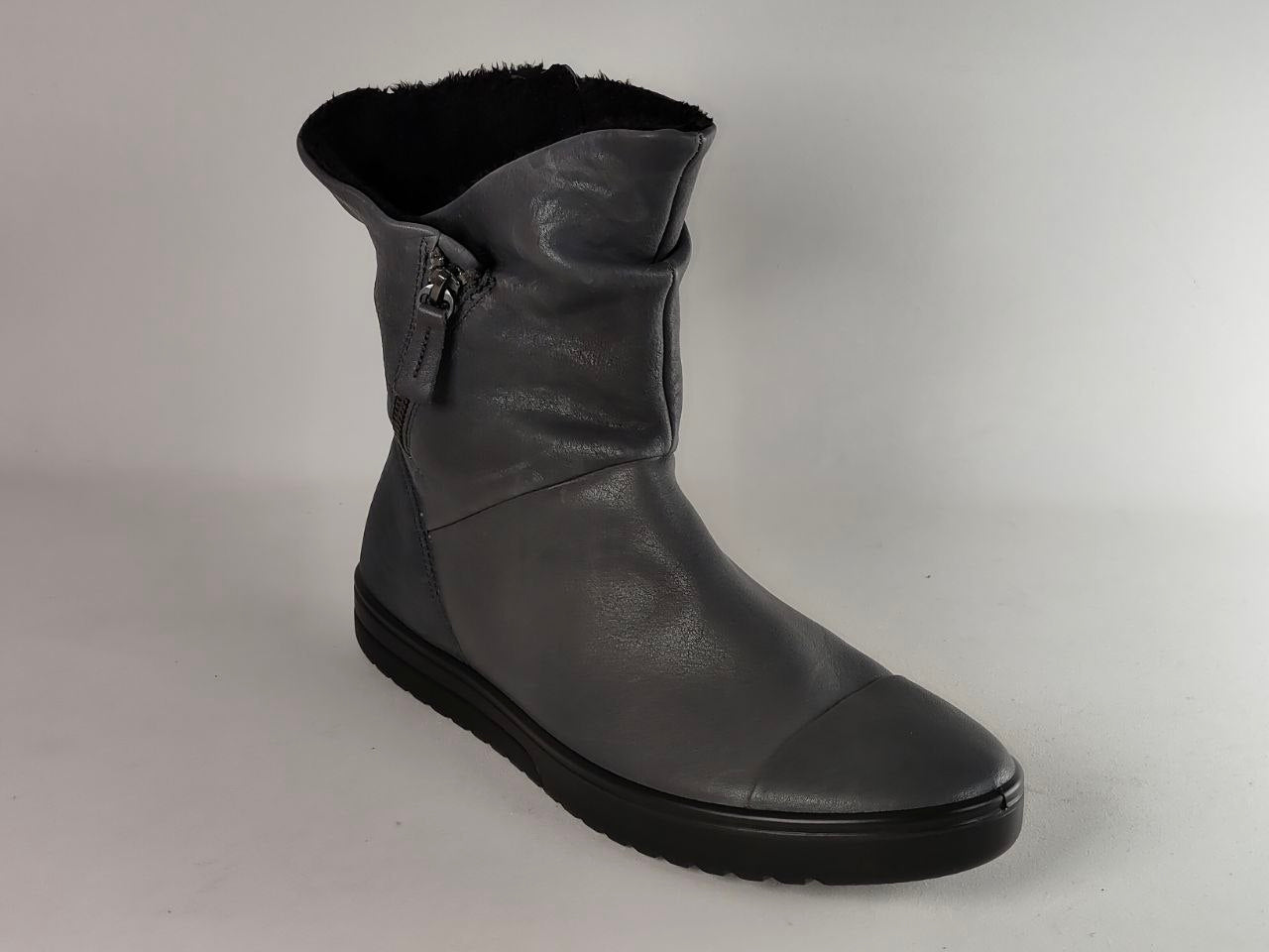 A single dark gray leather ankle boot with a black sole and black faux-fur lining, shown from a three-quarters angle on a light gray background.