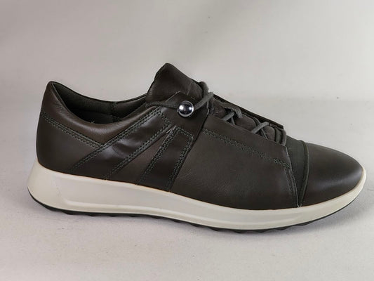 A dark brown leather low-top sneaker with a white sole, featuring a decorative silver metal rivet on the side and matching dark brown laces, shown against a neutral light gray background.