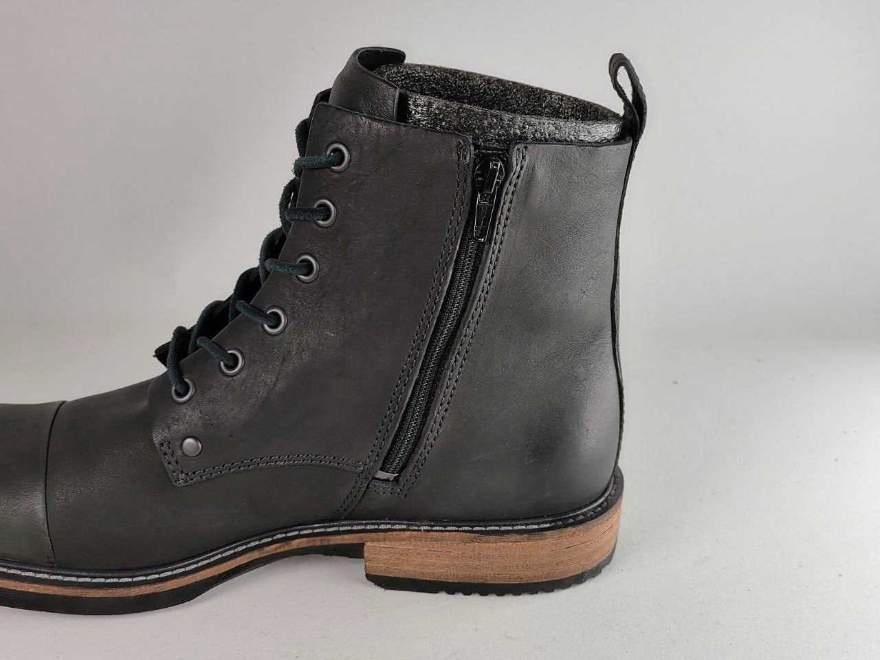 A dark gray leather lace-up ankle boot with a side zipper, a light brown wood-look heel, and a black sole, shown against a plain light gray background.