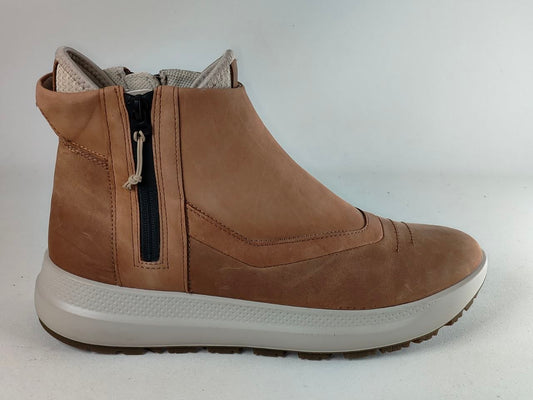 A light brown suede ankle boot with a side zipper, a thick white sole, and a gray interior lining, shown from a side profile view against a plain light gray background.