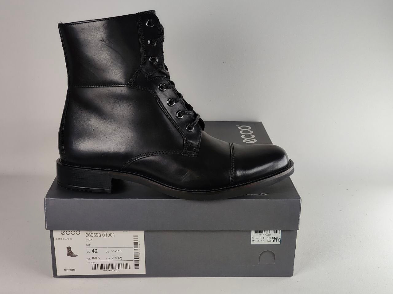 A black leather lace-up ankle boot by Ecco, displayed on top of its dark gray brand box against a neutral light gray background.