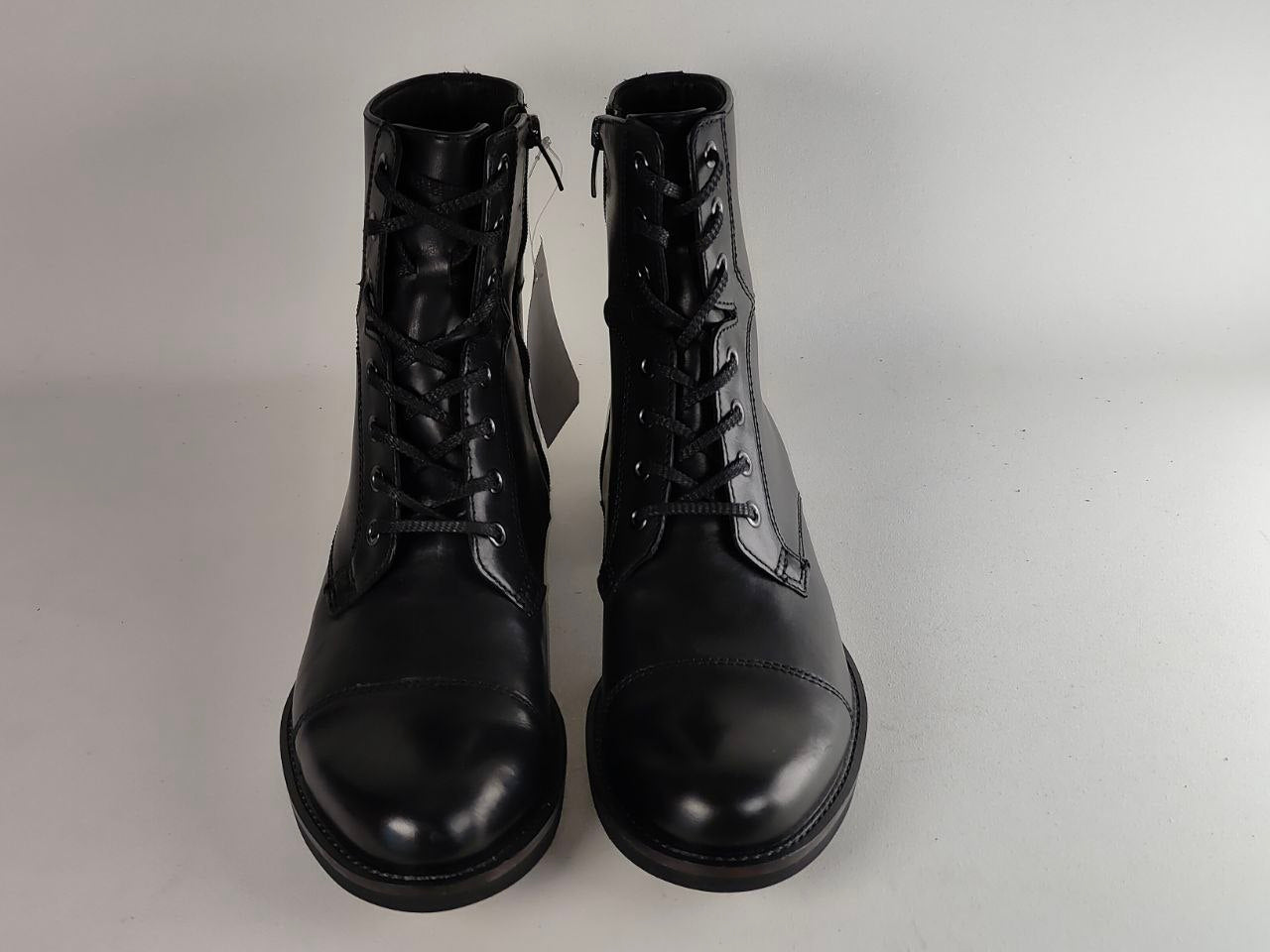 A pair of black leather lace-up ankle boots with side zippers, shown against a plain light gray background.