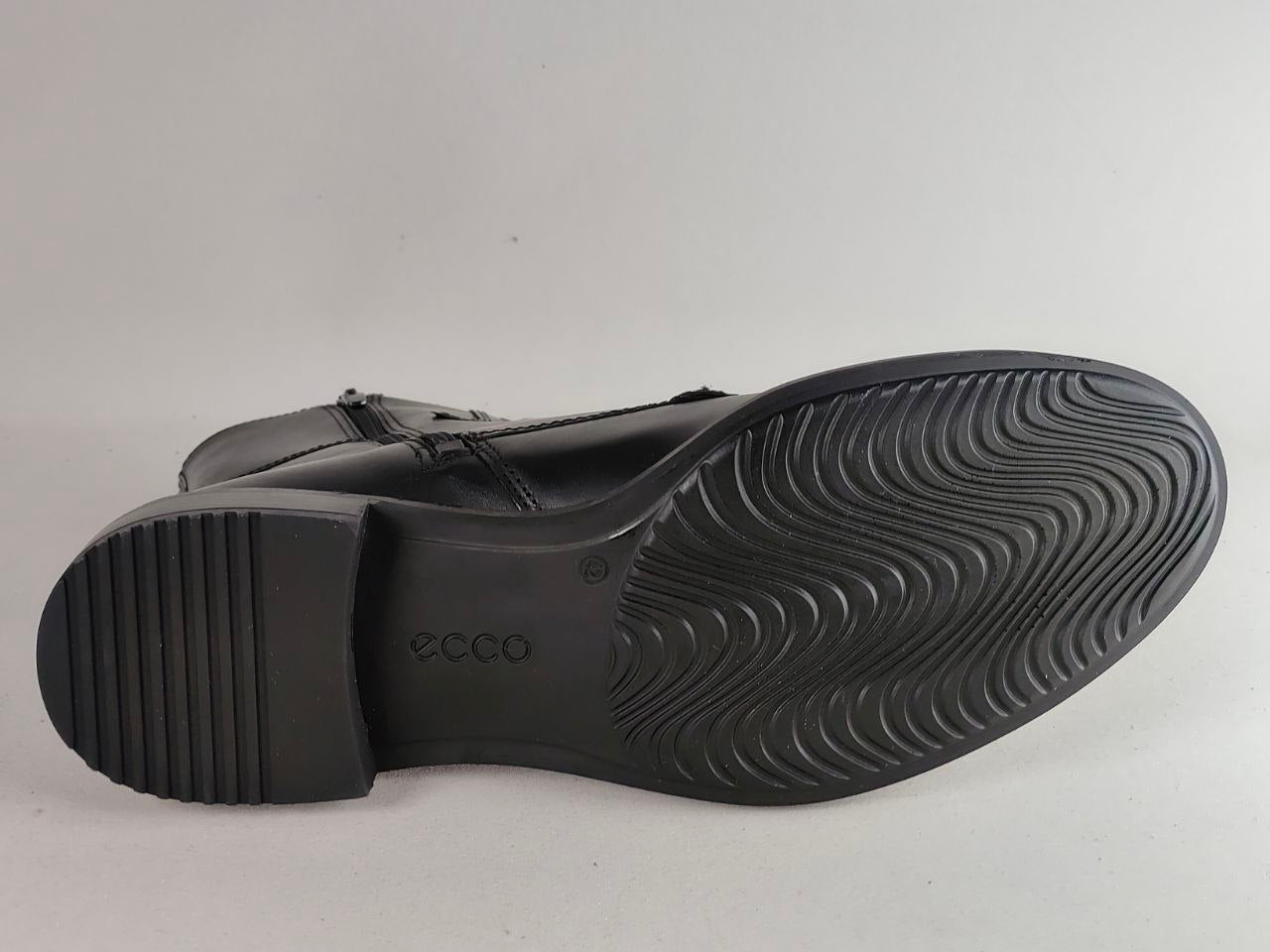 A black leather boot shown from the sole side, displaying a textured wavy tread pattern and the embossed ECCO brand name on the heel.
