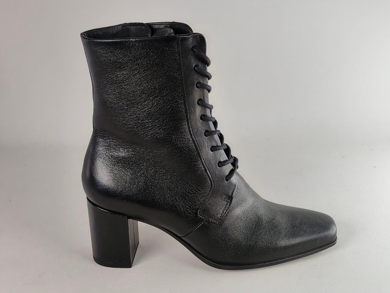 A black leather lace-up ankle boot with a block heel, shown from a side profile against a neutral light gray background.