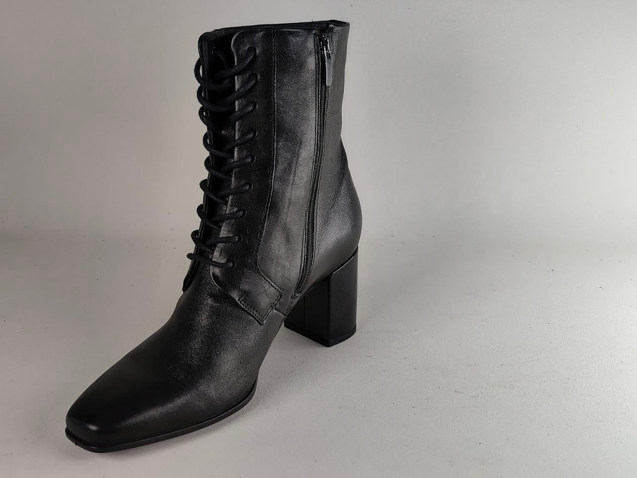 A black leather lace-up ankle boot with a block heel and side zipper, photographed on a neutral light gray background.