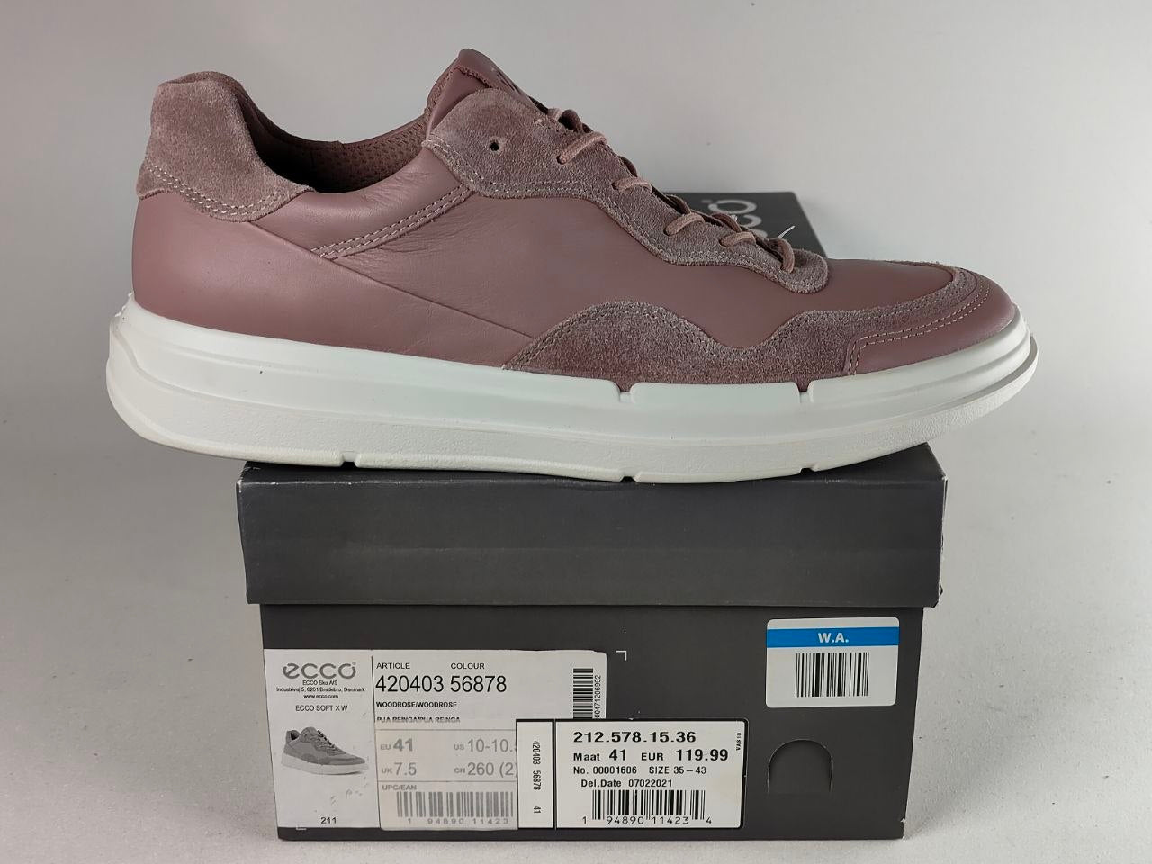A single ECCO low-top sneaker in a dusty mauve colorway, shown resting on top of its black retail shoebox against a neutral light gray background.