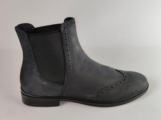 A dark gray leather Chelsea boot with decorative brogue perforations on the toe and side, featuring a black elastic side panel and a low black heel, shown against a light gray background.