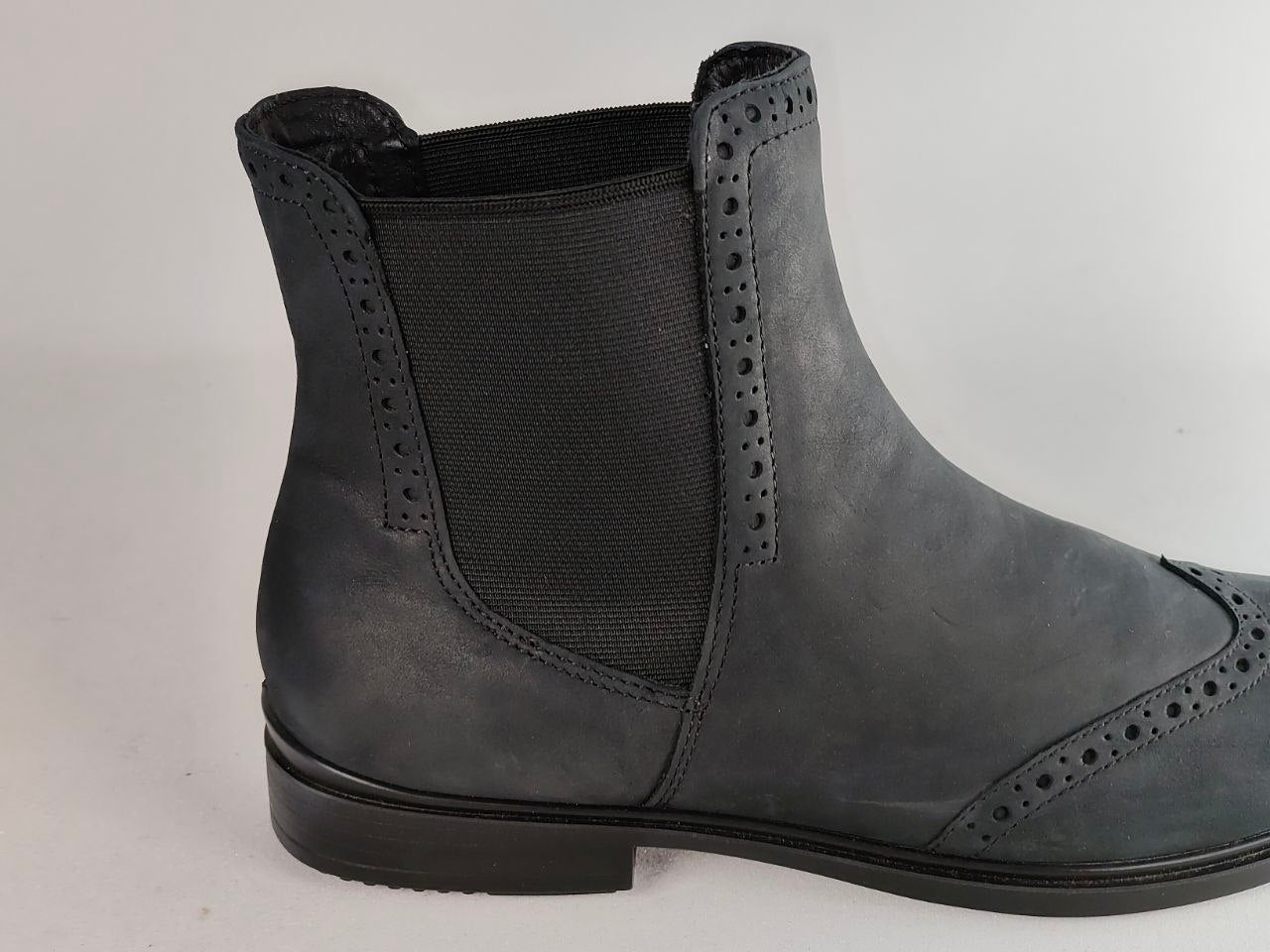 A dark gray leather Chelsea boot with a black elastic side panel and decorative brogue perforations, shown from a side profile view against a light gray background.