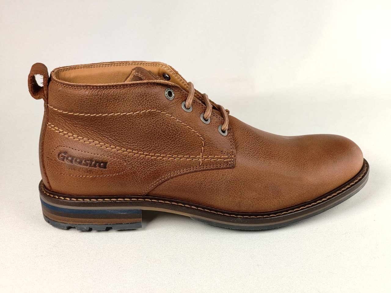 A single brown leather ankle boot with laces, shown in a side profile against a plain light background. The brand name 'Gastina' is embossed on the side of the heel.