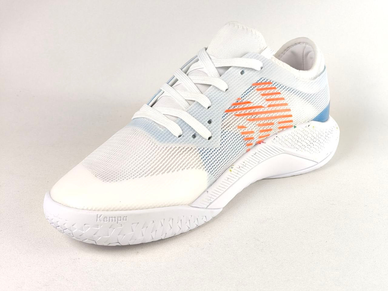 A Kappa athletic sneaker in white with a light blue mesh pattern, an orange geometric side logo, and a white textured sole.