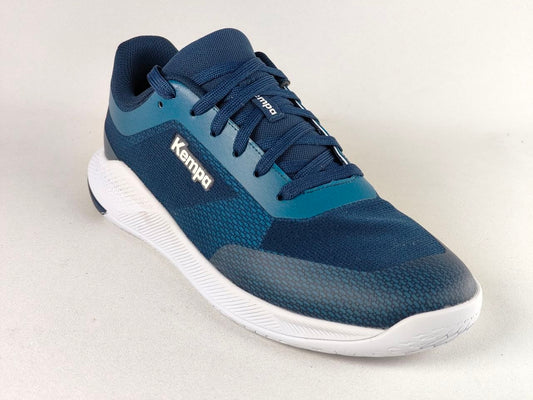 A single Kempa athletic shoe in navy blue and teal with a white sole, photographed on a light gray studio background.