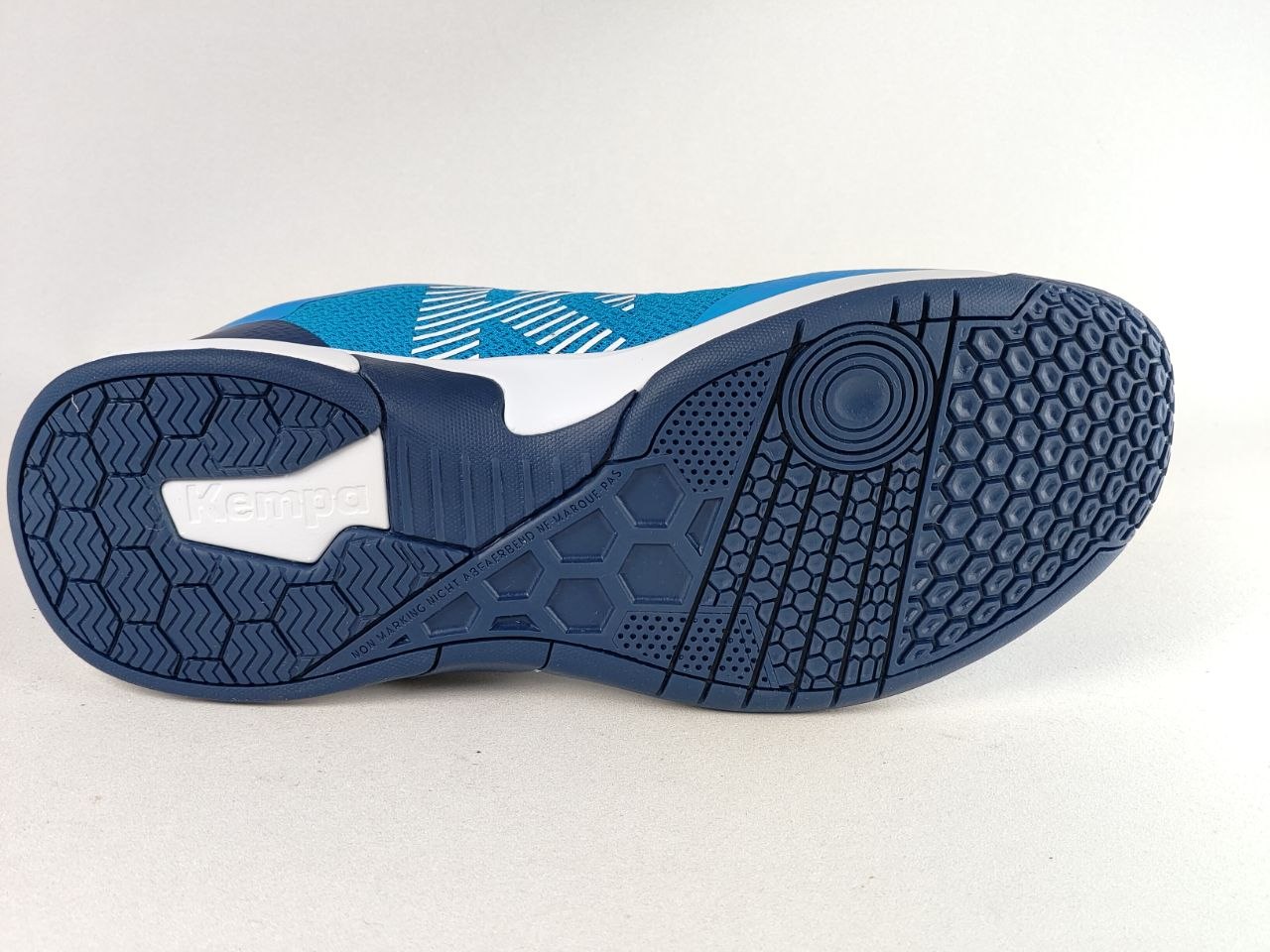 The outsole of a Kenda athletic shoe, showing a blue and white tread pattern on a light gray background.