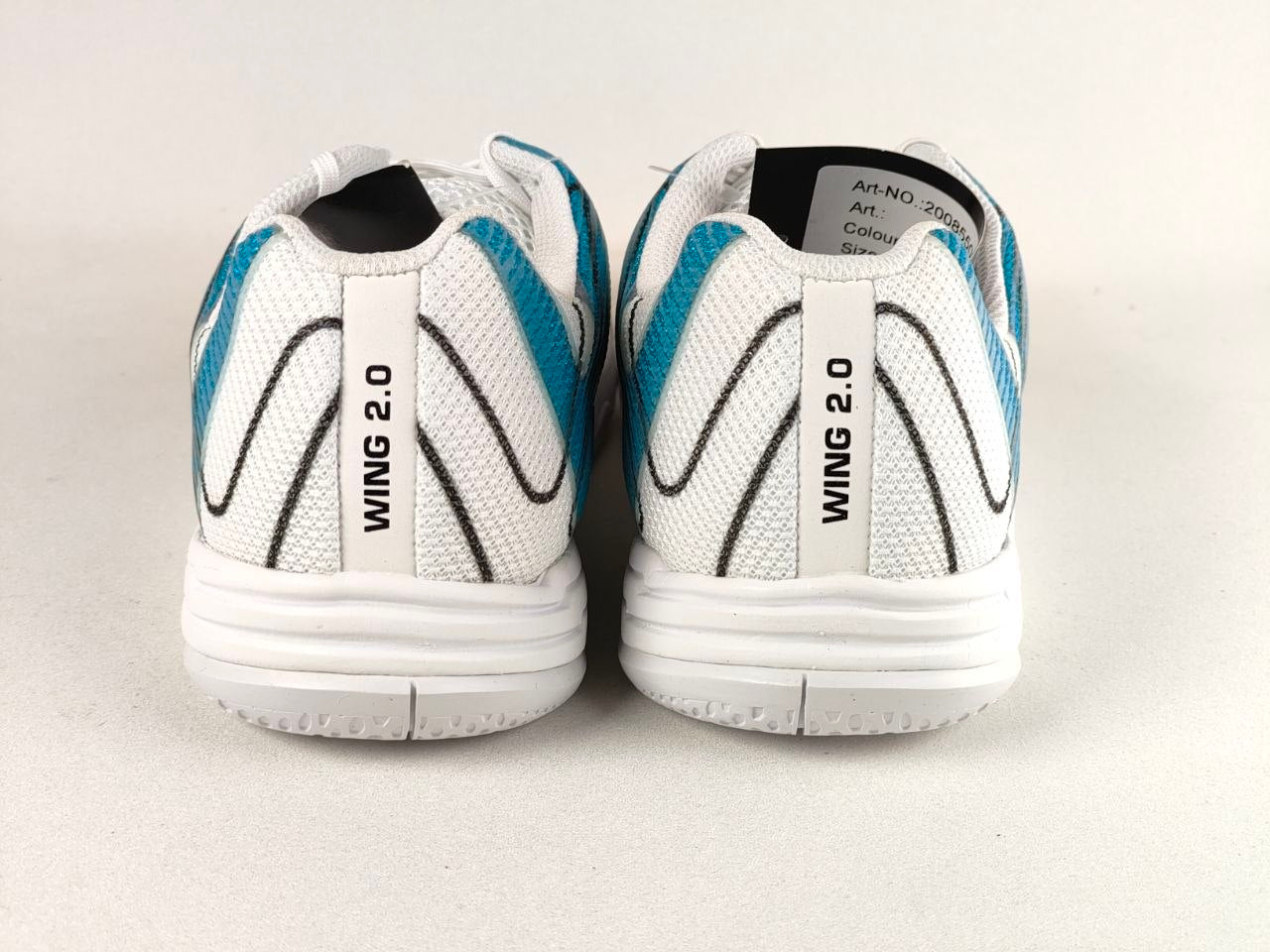 A pair of white Wing 2.0 athletic shoes shown from the back, featuring white mesh uppers with teal and black wavy accents, white midsoles, and a white heel tab printed with 'WING 2.