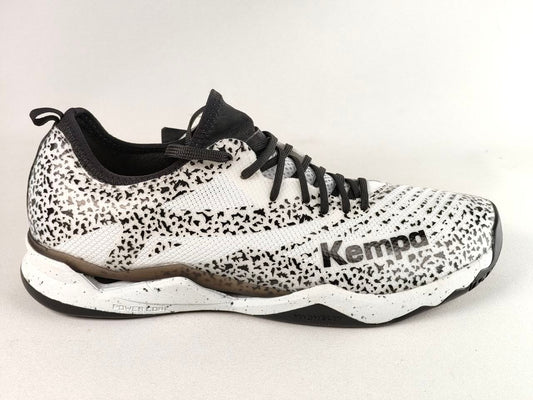 A Kempa athletic shoe featuring a white and black speckled pattern, black laces, and a black and white sole, shown against a plain light background.
