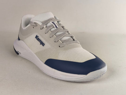 A low-top athletic sneaker by Kempa, featuring a light gray and white mesh upper with a navy blue toe cap and matching navy branding on the side, set against a neutral light gray background.