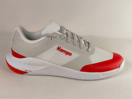 A light gray and white running shoe with red accents, featuring the Kempa logo on the side and a red toe cap, photographed against a neutral light gray background.