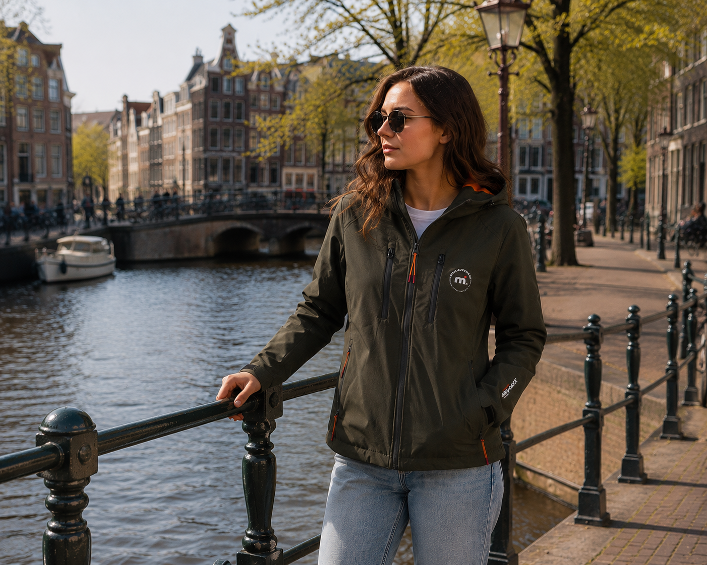 Woman standing by a canal with historic buildings in the background