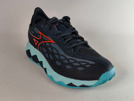 A Mizuno running shoe in black with a bright orange logo, a black and gray wavy mesh upper, and a light blue and black wavy sole, shown on a neutral light gray background.
