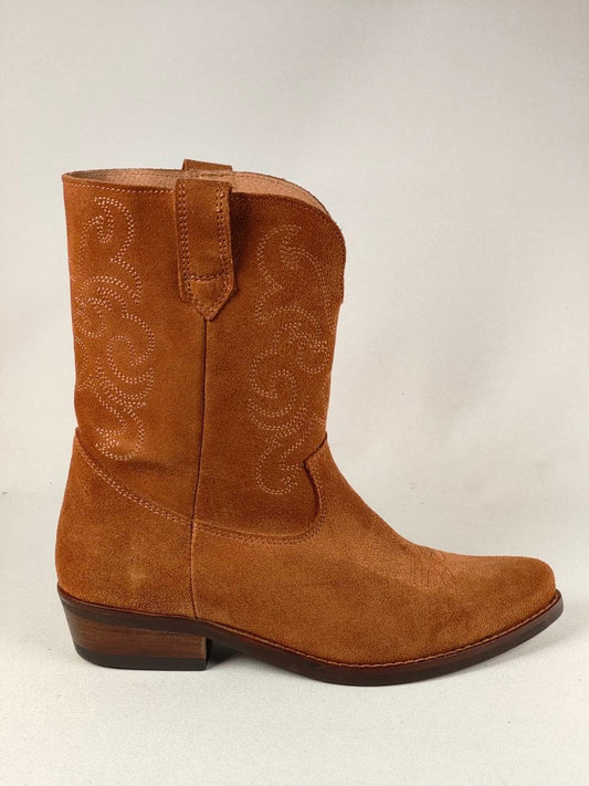 A single brown suede western boot with decorative cutout embroidery on the shaft, shown in profile against a light gray background.