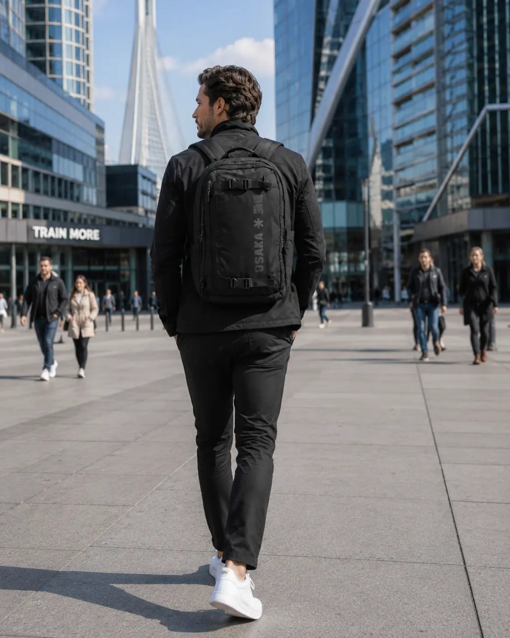 Man walking in a cityscape with a black backpack