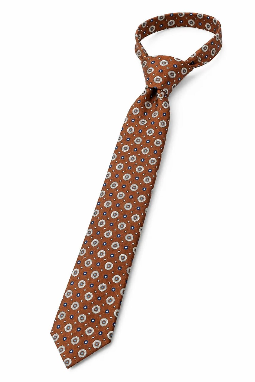 A brown patterned State of Art Modern Classics silk tie on a white background