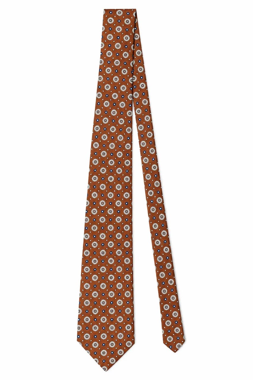 Part of a Brown patterned tie on a white background